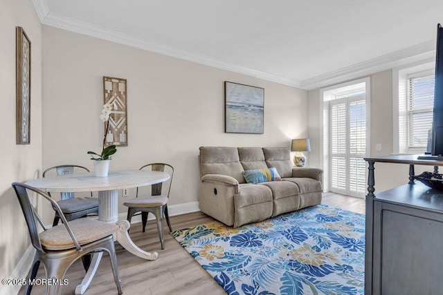 living room featuring ornamental molding and light hardwood / wood-style floors