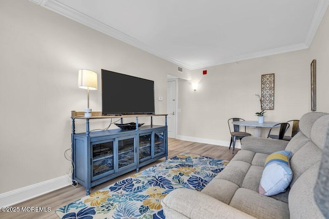 living room with hardwood / wood-style floors and crown molding