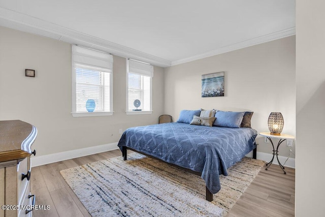 bedroom with light hardwood / wood-style floors and ornamental molding