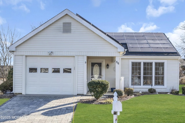 single story home with a front lawn, a garage, and solar panels