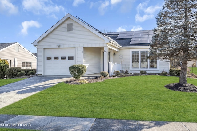 single story home with a garage, a front lawn, and solar panels