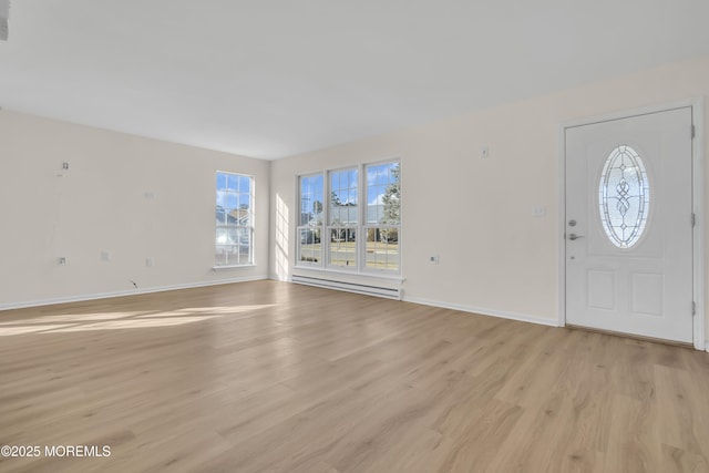 foyer entrance with light hardwood / wood-style floors and a baseboard radiator