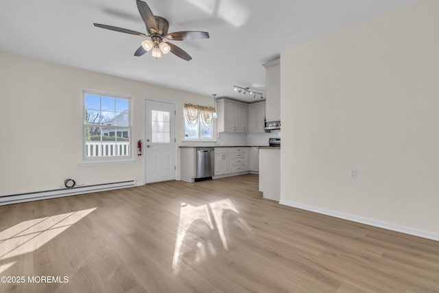 kitchen featuring extractor fan, a baseboard heating unit, ceiling fan, appliances with stainless steel finishes, and light hardwood / wood-style flooring