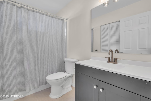 bathroom featuring toilet and vanity