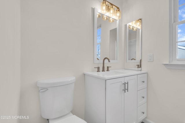 bathroom featuring toilet and vanity