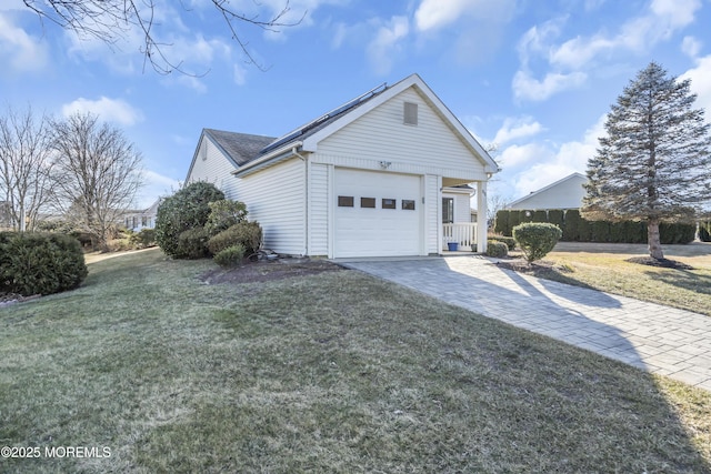 view of side of property featuring a lawn and a garage