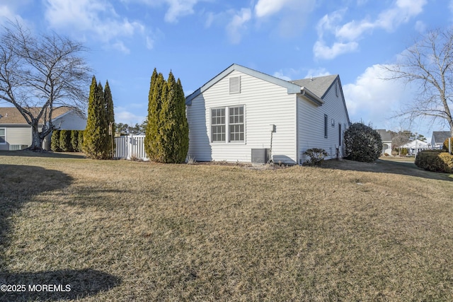 view of side of property with a lawn