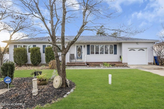 single story home featuring a garage and a front yard