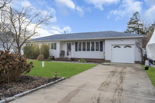 single story home featuring a garage and a front lawn