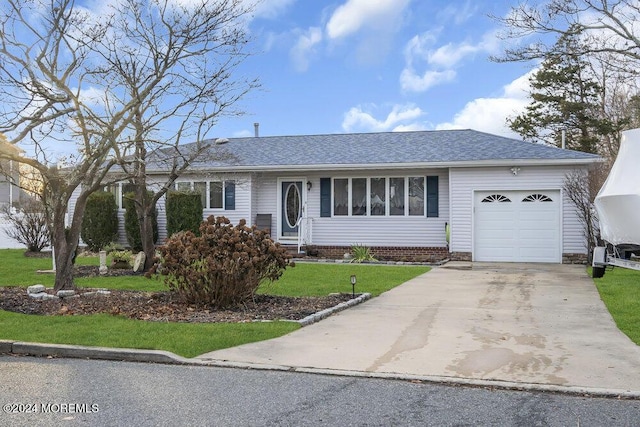 single story home with a garage and a front yard