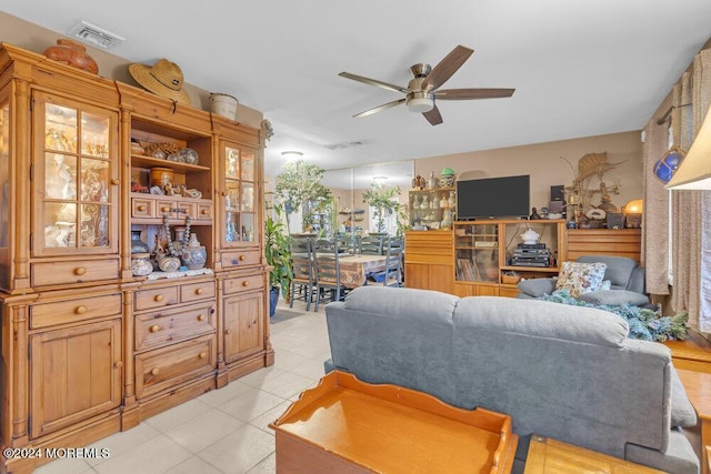 tiled living room featuring ceiling fan