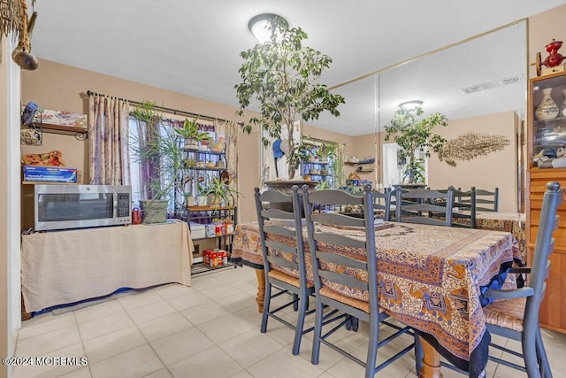 dining area with light tile patterned flooring