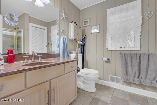 bathroom with vanity, tile patterned floors, wooden walls, and crown molding