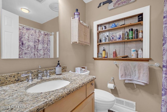 bathroom with toilet and vanity