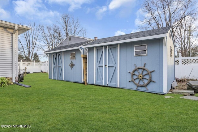 view of outbuilding featuring a yard