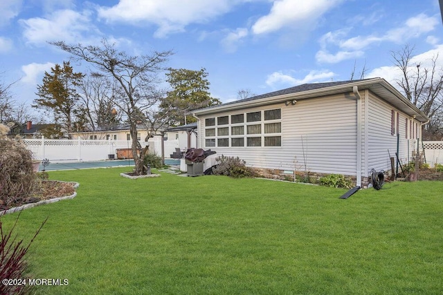 back of house featuring a yard