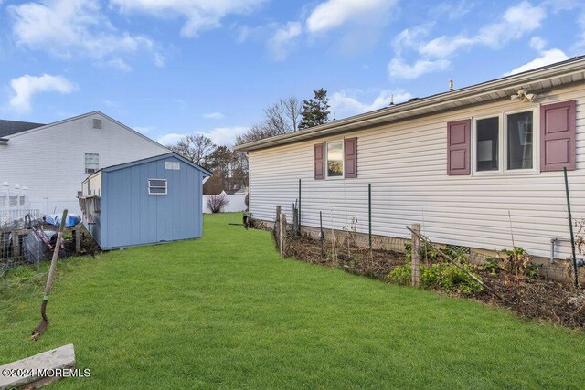 exterior space featuring a storage unit and a lawn