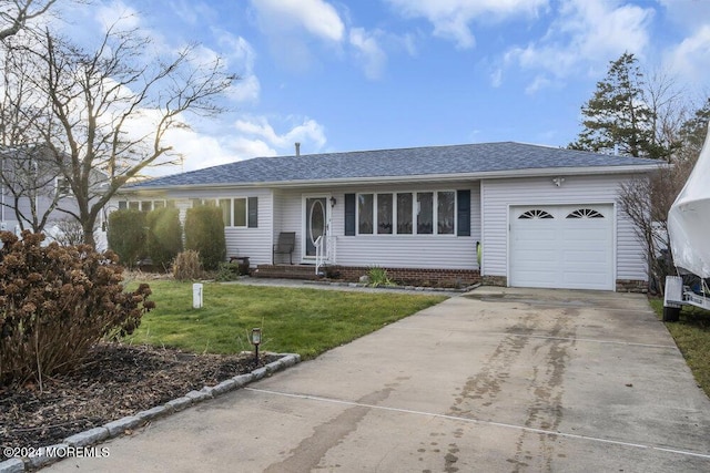 ranch-style home with a front yard and a garage