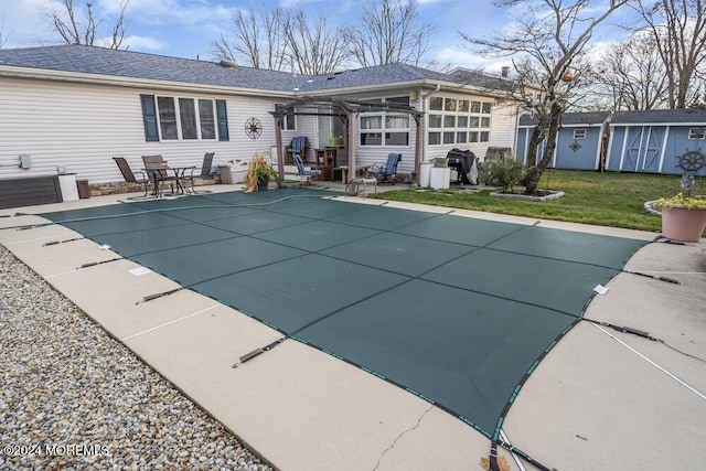 view of swimming pool with grilling area, a pergola, a patio area, and a yard