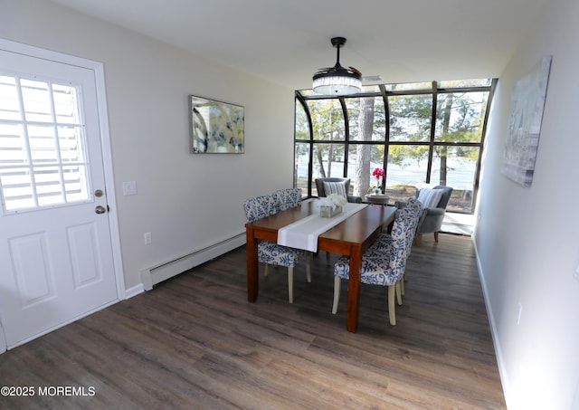 dining space with baseboard heating, a wealth of natural light, and dark hardwood / wood-style floors