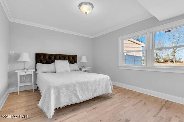 bedroom featuring crown molding and light hardwood / wood-style floors