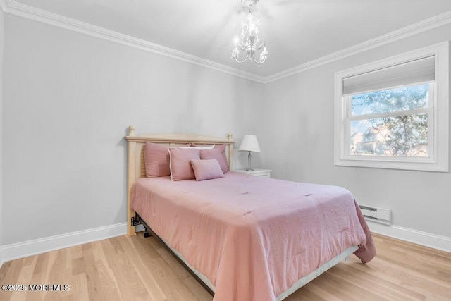 bedroom featuring baseboard heating, ornamental molding, light hardwood / wood-style flooring, and a notable chandelier