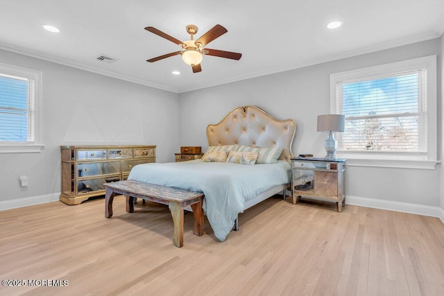 bedroom with ceiling fan, ornamental molding, and light hardwood / wood-style flooring