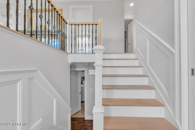 stairs featuring hardwood / wood-style flooring