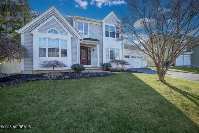 view of front property featuring a front lawn and a garage