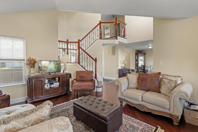 living room featuring lofted ceiling and dark hardwood / wood-style floors