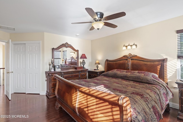 bedroom with a closet, ceiling fan, and dark wood-type flooring