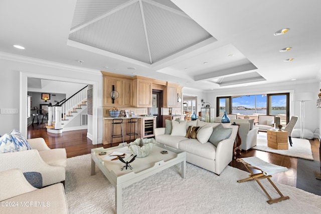 living room featuring wood-type flooring, crown molding, and wine cooler