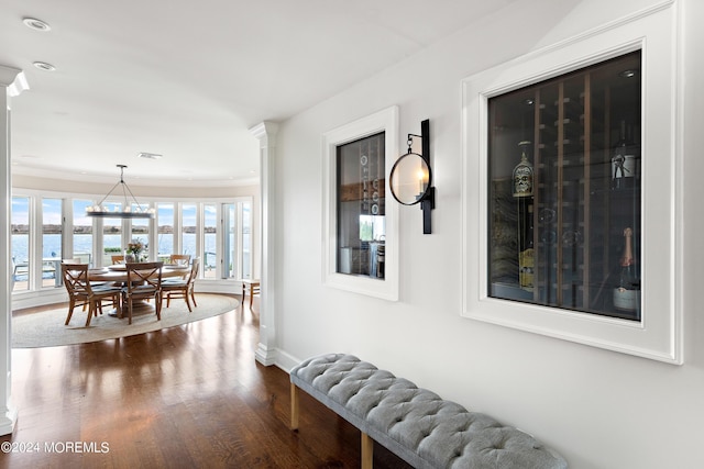 hallway with hardwood / wood-style flooring and a water view