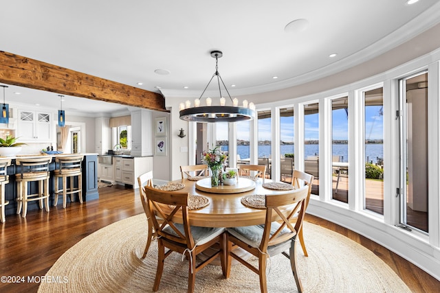 dining room featuring a water view, ornamental molding, dark hardwood / wood-style floors, a chandelier, and beam ceiling