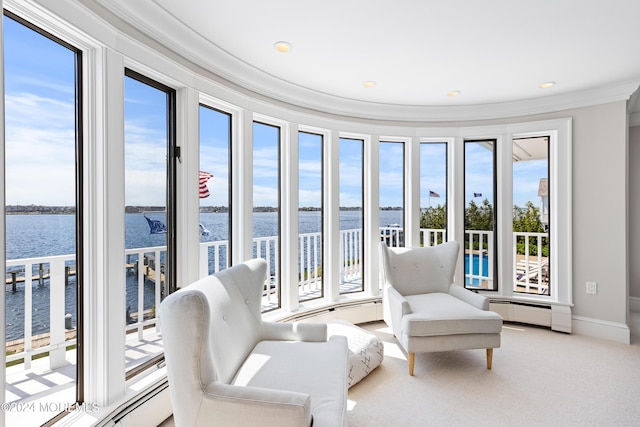 sunroom featuring a water view and a baseboard radiator