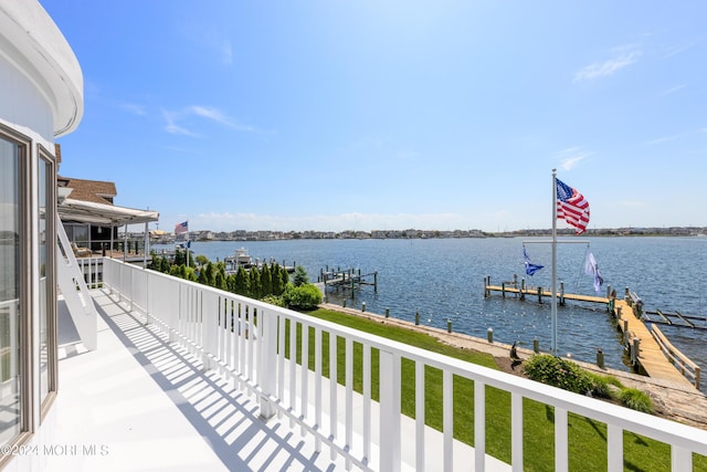 balcony featuring a dock and a water view