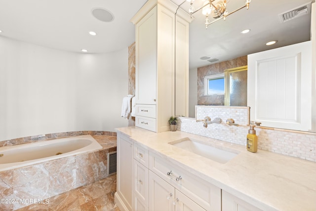 bathroom with an inviting chandelier, vanity, and shower with separate bathtub