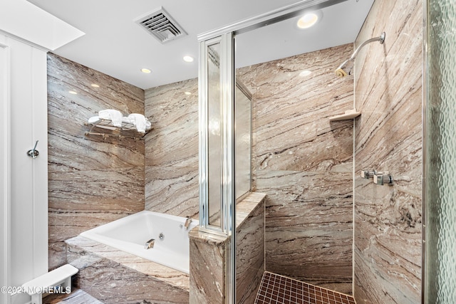 bathroom featuring shower with separate bathtub