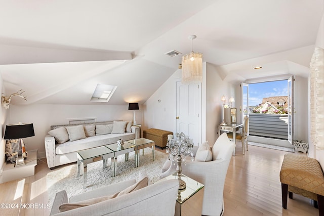 living room featuring light hardwood / wood-style flooring and lofted ceiling