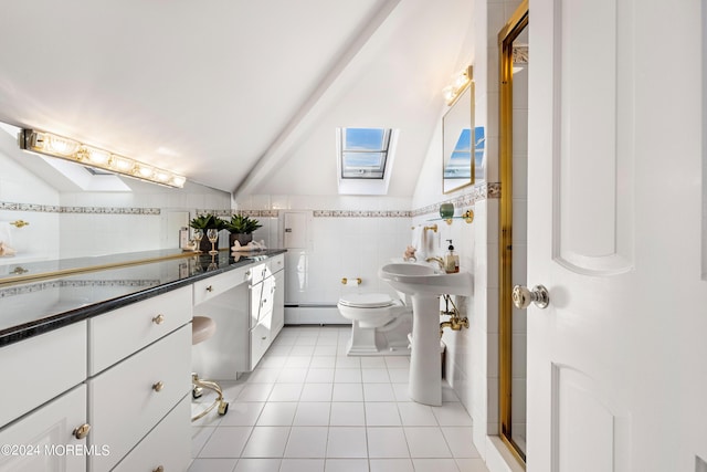 bathroom featuring toilet, tile patterned flooring, vaulted ceiling with skylight, tile walls, and a baseboard heating unit