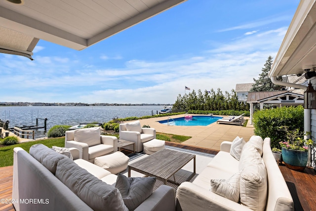 view of patio with an outdoor living space and a water view