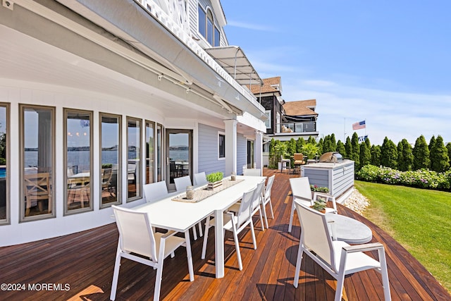 wooden terrace with a lawn