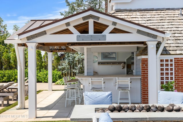 view of patio featuring exterior bar and a gazebo