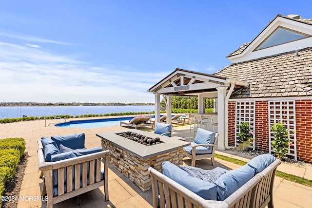 view of patio featuring an outdoor living space with a fire pit, an outdoor bar, a water view, and a gazebo