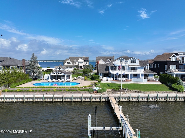 view of dock featuring a patio, a water view, and a gazebo