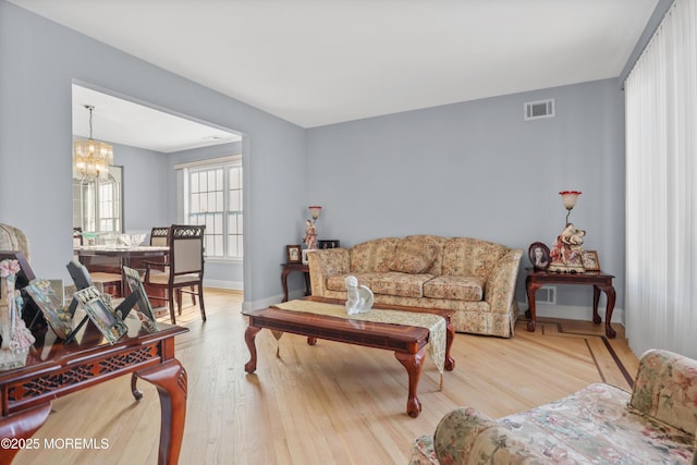 living room featuring a chandelier and wood-type flooring