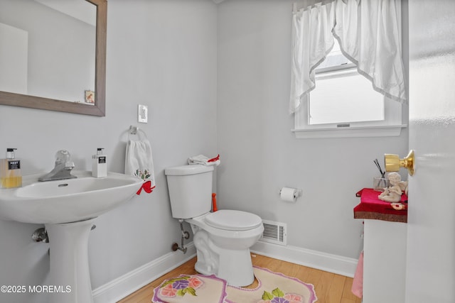 bathroom featuring toilet and hardwood / wood-style flooring