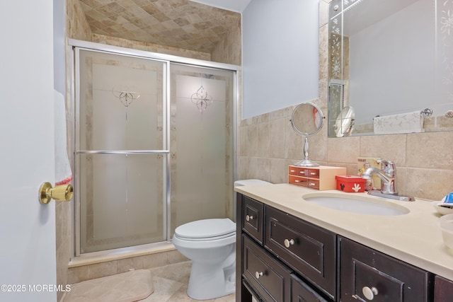 bathroom featuring tile walls, toilet, walk in shower, and vanity