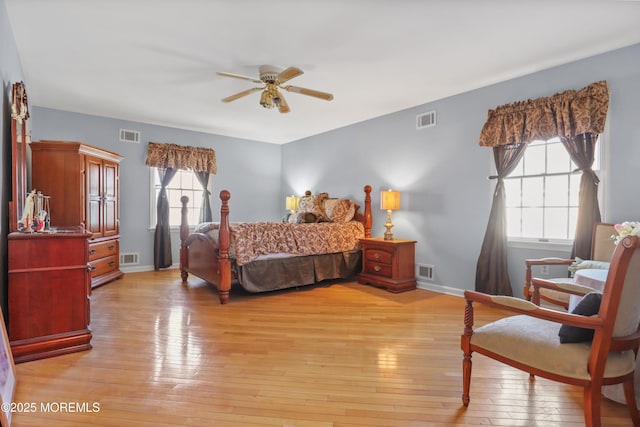 bedroom with multiple windows, ceiling fan, and light hardwood / wood-style floors