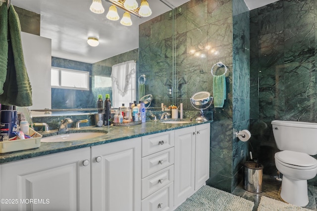 bathroom with tile walls, toilet, and vanity